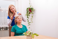 Caregiver combing the hair of a senior